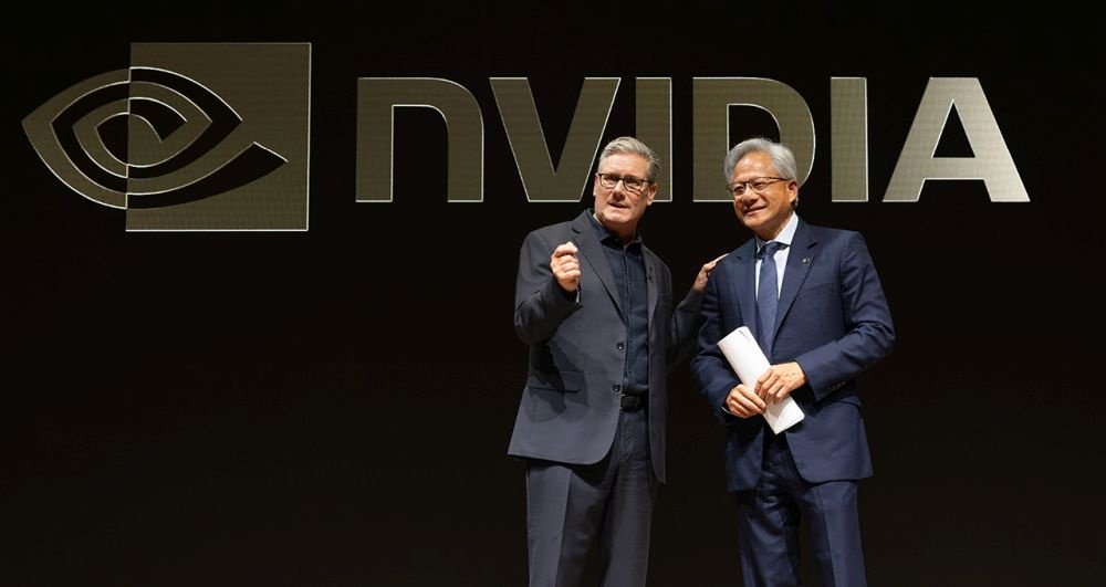 Two men stand on stage in front of NVIDIA logo.